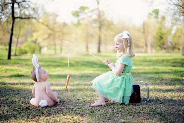 Adorable Sibling Easter Photo. The little girl is fishing, but she doesn’t go for a fish, there is a carrot hang with the fishing rod. The little baby, the girl’s little brother with the bunny ears looks like the rabbit. This sibling Easter photo is just so interesting.