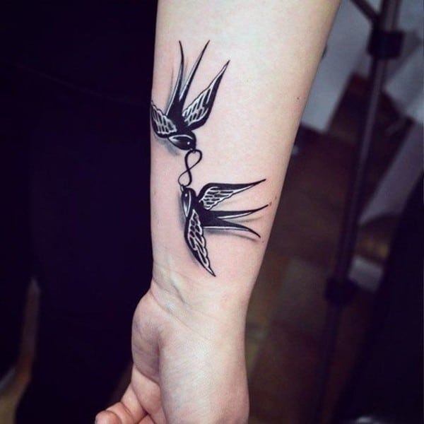 birds carrying infinity symbol tattoo on wrist