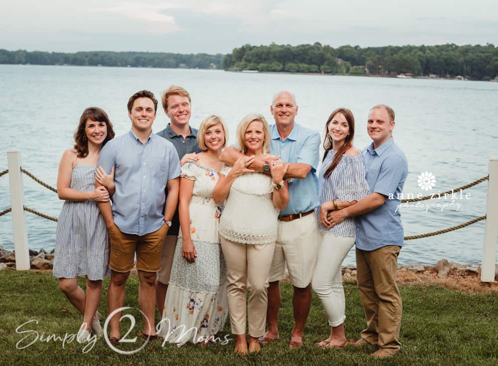 Two generations with adult children in front of a lake