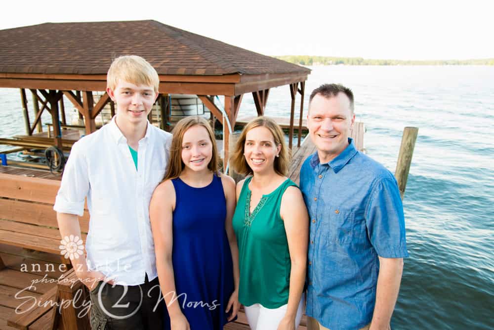 family of four standing by a covered dock