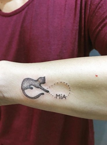 cat and dots design with a name tattoo