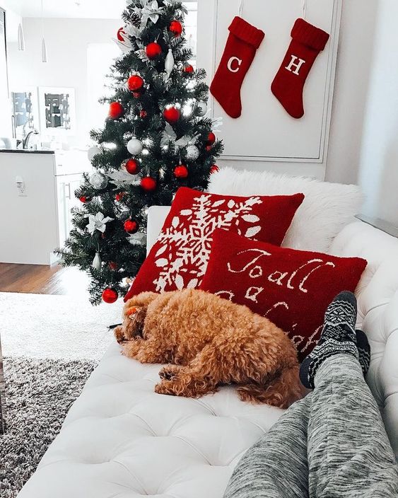 Christmas wallpaper aesthetic with dog, Christmas stockings and white and red decorated Christmas tree
