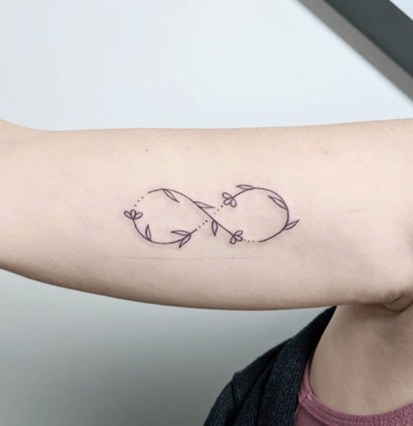 delicate line art flower infinity tattoo