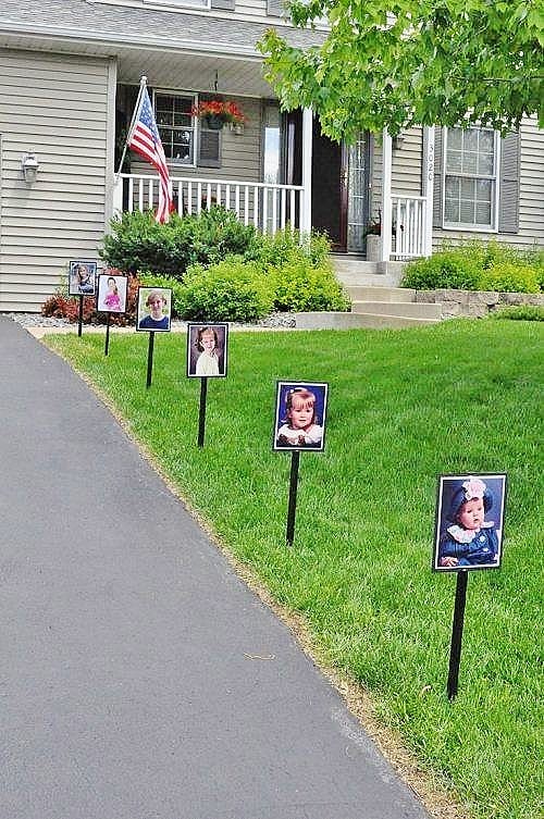 School pictures on stakes lining the driveway.. Easy DIY Graduation Party Decoration Ideas using Pictures.