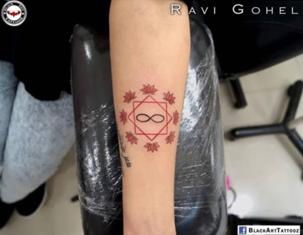 infinity inside geometric design with red lotuses tattoo