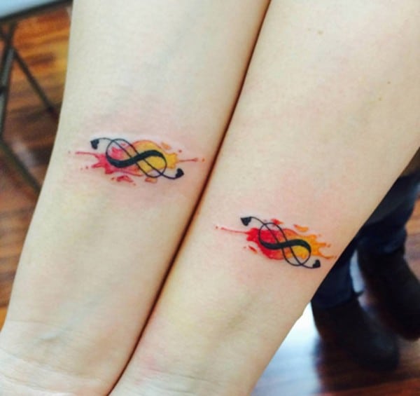 colorful matching infinity tattoos on arms