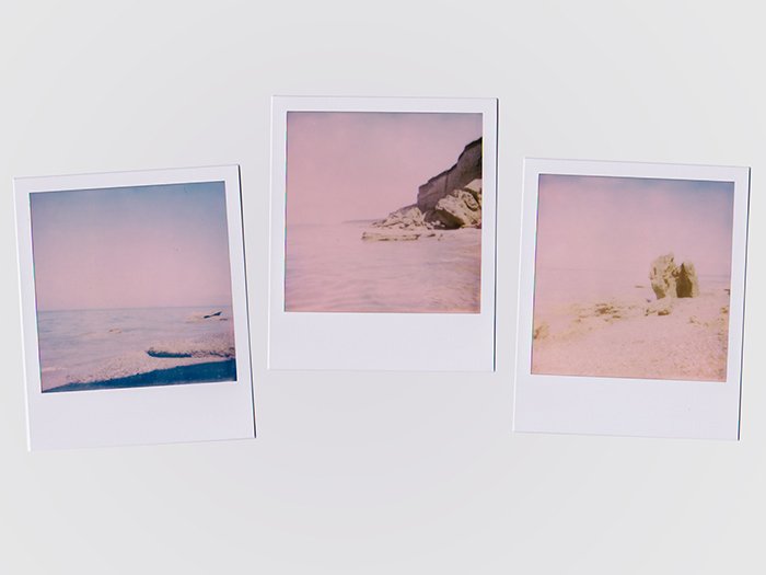 Photo of three Polaroid pictures in a pinkish hue