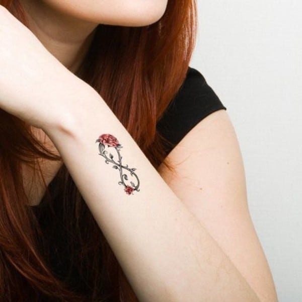 red roses with thorns tattoo on wrist