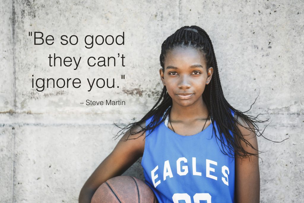 Female basketball player standing against wall with school quotes overlay.